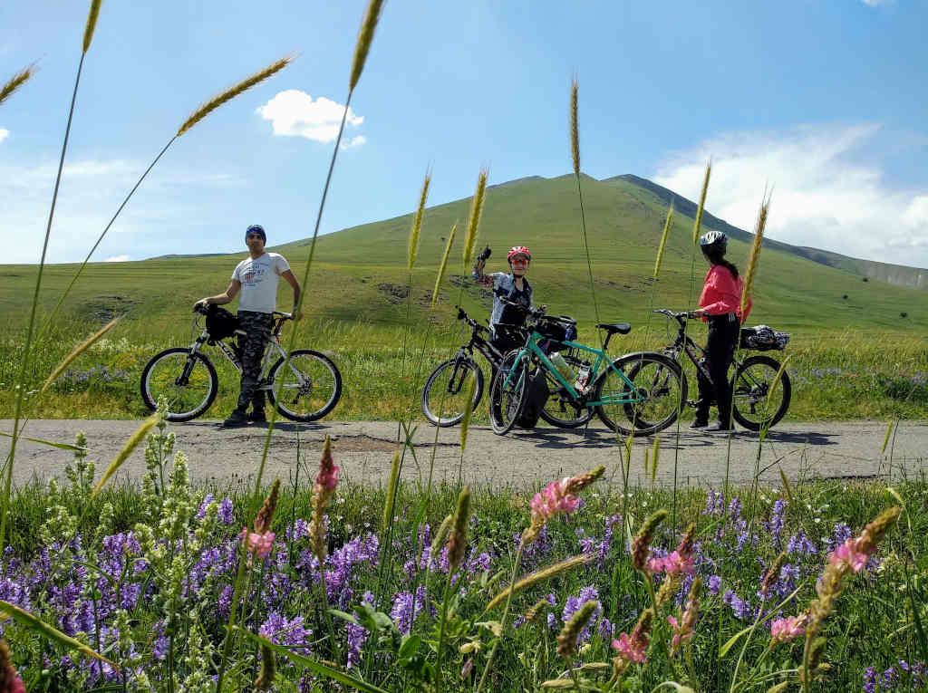 Mount Hatis and three cyclists in front of in