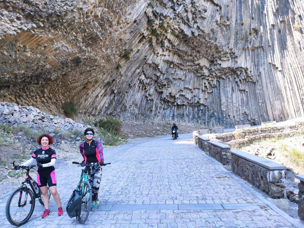 basalt columns with two cyclists in front